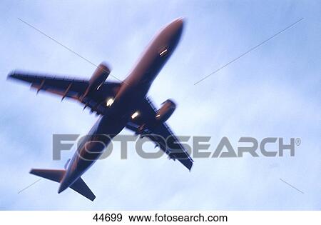 Low angle view of airplane in flight, Frankfurt, Germany View Large Photo Image Stock Photo - Low angle view of airplane in flight, Frankfurt, Germany . Fotosearch