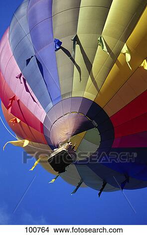Low angle view of hot air balloon flying View Large Photo Image Picture - Low angle view of hot air balloon flying . Fotosearch