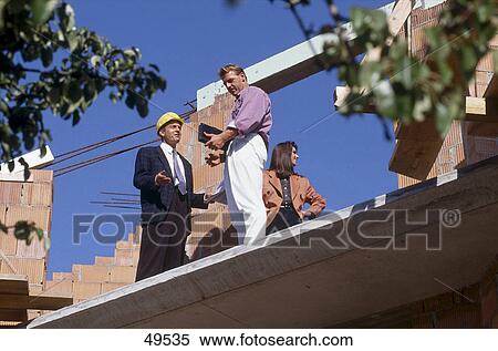 Low angle view of man talking to architect at construction site View Large Photo Image Stock Photography - Low angle view of man talking to architect at construction site . Fotosearch