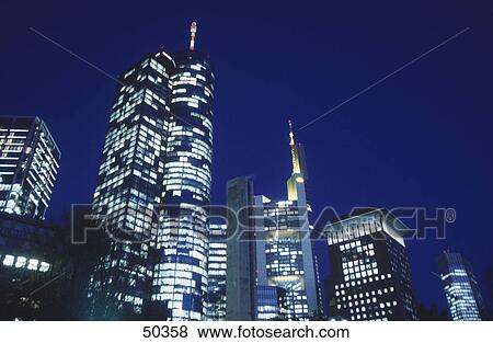 Low angle view of skyscrapers lit up at night, Frankfurt, Hesse, Germany View Large Photo Image Stock Photo - Low angle view of skyscrapers lit up at night, Frankfurt, Hesse, Germany . Fotosearch