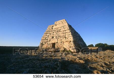 Picture - Low angle view of tomb, Naveta des Tudons, Minorca, Balearic Islands, Spain . Fotosearch