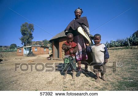 Low angle view of woman standing with her grandchildren View Large Photo Image Stock Image - Low angle view of woman standing with her grandchildren . Fotosearch