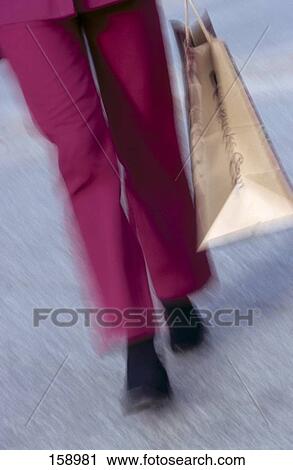 Low section view of person carrying shopping bag View Large Photo Image Stock Image - Low section view of person carrying shopping bag . Fotosearch