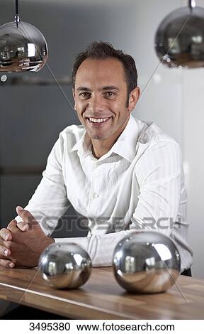Man leaning on counter View Large Photo Image Stock Image - Man leaning on counter . Fotosearch