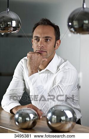 Man leaning on counter View Large Photo Image Stock Image - Man leaning on counter . Fotosearch
