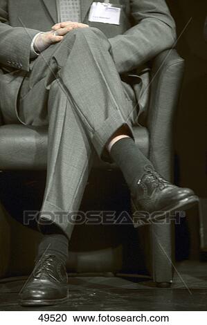 Man sitting in armchair, lower section View Large Photo Image Stock Image - Man sitting in armchair, lower section . Fotosearch