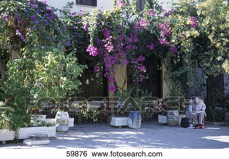 Man sitting in courtyard of building, Rhodes, Dodecanese Islands, Greece View Large Photo Image Stock Photograph - Man sitting in courtyard of building, Rhodes, Dodecanese Islands, Greece . Fotosearch