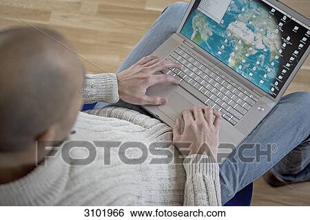 Man using laptop View Large Photo Image Stock Photograph - Man using laptop . Fotosearch