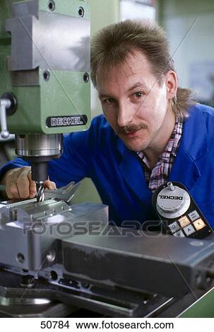 Picture - Mechanic standing at work bench . Fotosearch
