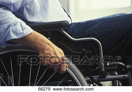 Stock Photo - Mid section view of man on wheelchair . Fotosearch