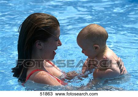 Mother and baby in swimming pool View Large Photo Image Stock Image - Mother and baby in swimming pool . Fotosearch
