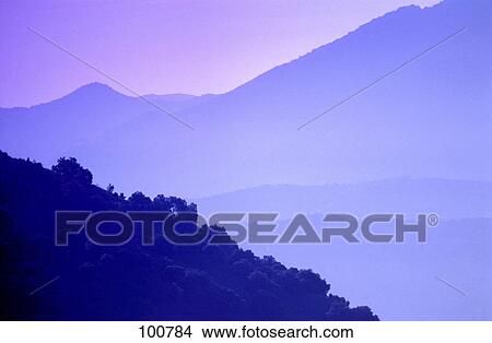 Picture - Mountain range covered with fog . Fotosearch