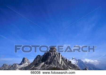 Stock Photo - Mountains against blue sky, Dolomites, South Tyrol, Italy . Fotosearch