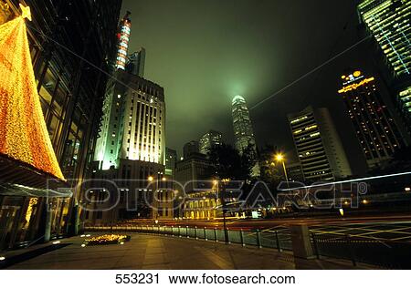 Stock Image - Office buildings lit up at night, Hong Kong, China . Fotosearch