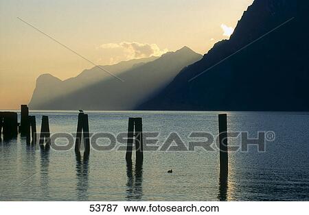 Stock Photo - Old wooden stumps of pier in lake, Lake Garda, Trentino, Trentino-Alto Adige, Italy . Fotosearch