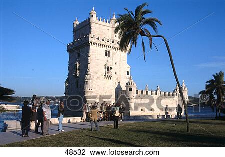 Stock Image - Palm tree in front of lighthouse, Belem Tower, Belem, Lisbon, Portugal . Fotosearch