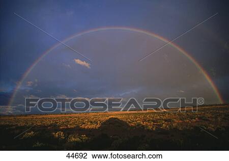 Stock Image - Panoramic view of landscape with rainbow, Nullarbor Plain, South Australia, Australia . Fotosearch