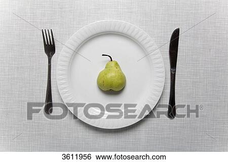 Pear on a plate with fork and knife View Large Photo Image Stock Photograph - Pear on a plate with fork and knife . Fotosearch