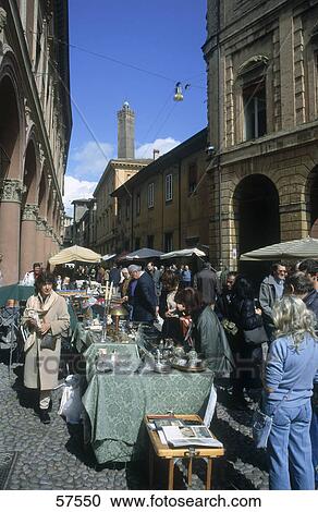 Stock Image - People at a flea market, Piazza Santo Stefano, Bologna, Emilia-Romagna, Italy . Fotosearch