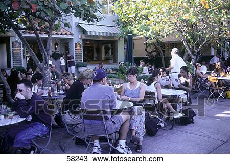 Stock Image - People sitting at sidewalk cafe, Miami Beach, Florida, USA . Fotosearch