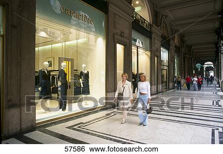 People walking in front of clothing store, Turin, Piedmont, Italy View Large Photo Image Stock Photograph - People walking in front of clothing store, Turin, Piedmont, Italy . Fotosearch