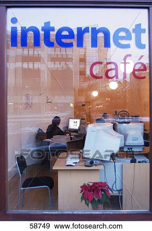 People working on computer in internet cafe viewed through window glass View Large Photo Image Stock Photo - People working on computer in internet cafe viewed through window glass . Fotosearch