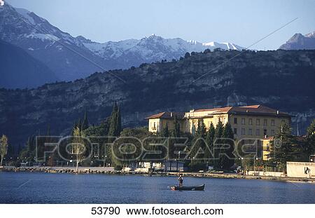 Stock Image - Person on boat in lake, Lake Garda, Torbole, Veneto, Italy . Fotosearch