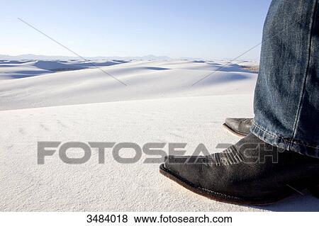 Stock Photo - Person wearing cowboy boots, White Sands National Monument, New Mexico, USA . Fotosearch