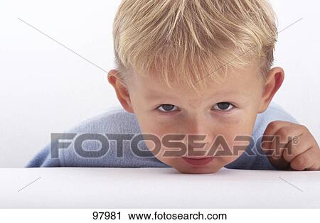 Stock Image - Portrait of boy looking serious . Fotosearch