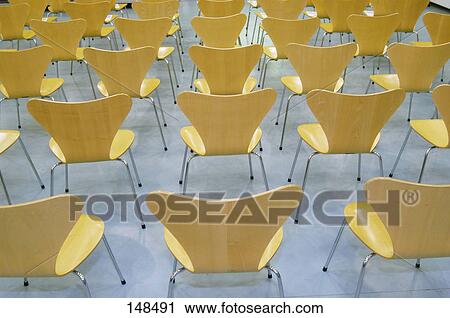 Stock Image - Rear view of empty chairs of concert hall . Fotosearch