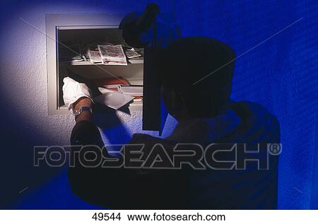 Rear view of thief stealing from vault View Large Photo Image Picture - Rear view of thief stealing from vault . Fotosearch