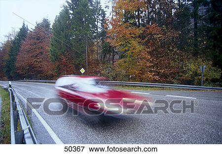 Red car in motion on country road View Large Photo Image Stock Photo - Red car in motion on country road . Fotosearch