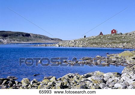 Stock Image - Red wooden house in bay, Aurland, Sogn Og Fjordane, Norway . Fotosearch