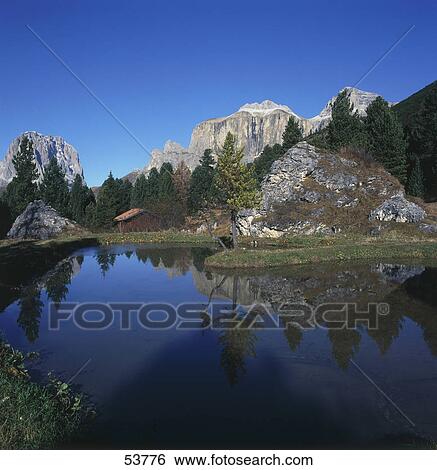 Stock Photograph - Reflection of mountains in lake, Sella Group, Langkofel, Pordoijoch, Dolomites, Alto Adige, Italy . Fotosearch