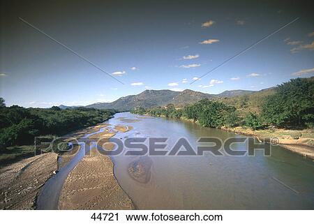 Stock Image - River flowing through mountains, Mkondo River, Swaziland . Fotosearch