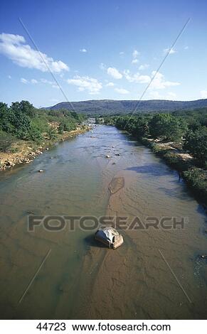 Stock Image - River flowing through mountains, Mkondo River, Swaziland . Fotosearch