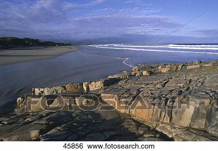 Stock Photograph - Rock formations on beach, Plettenberg Bay, Western Cape Province, South Africa . Fotosearch