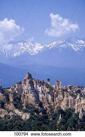 Rock formations on landscape with mountains in background, Pyrenees, Ille Sur Tet, France View Large Photo Image Picture - Rock formations on landscape with mountains in background, Pyrenees, Ille Sur Tet, France . Fotosearch