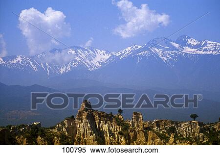 Stock Photography - Rock formations on landscape with mountains in background, Pyrenees, Ille Sur Tet, France . Fotosearch