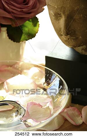 Stock Image - Rose petals and water in bowl . Fotosearch