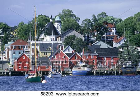 Stock Image - Sailboats in front of houses, Lunenburg, Nova Scotia, Canada . Fotosearch