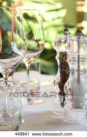 Salt and pepper shaker with stem glass on table View Large Photo Image Stock Image - Salt and pepper shaker with stem glass on table . Fotosearch