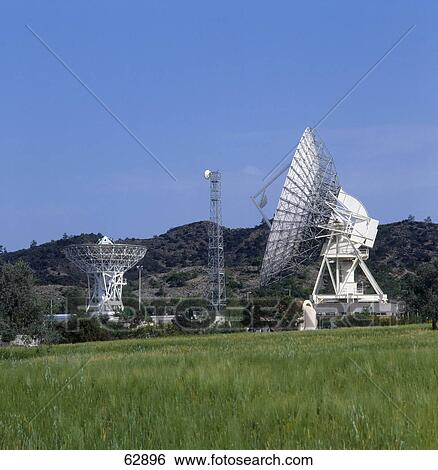 Stock Photograph - Satellites at station on landscape, Makarios Satellite Earth Station, Cyprus . Fotosearch