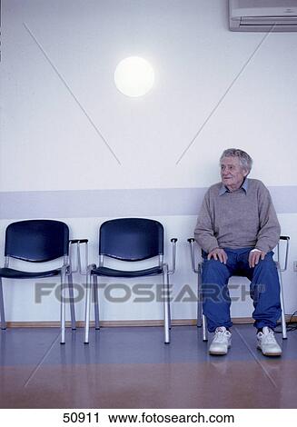 Stock Image - Senior man sitting on chair in hospital . Fotosearch