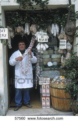 Shopkeeper standing in butcher shop, Norcia, Umbria, Italy View Large Photo Image Stock Image - Shopkeeper standing in butcher shop, Norcia, Umbria, Italy . Fotosearch