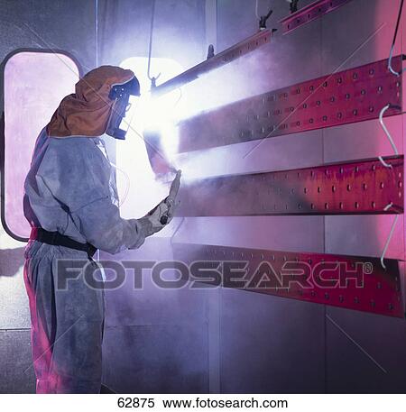Side profile of man wearing protective clothing and painting metal wall View Large Photo Image Stock Photography - Side profile of man wearing protective clothing and painting metal wall . Fotosearch