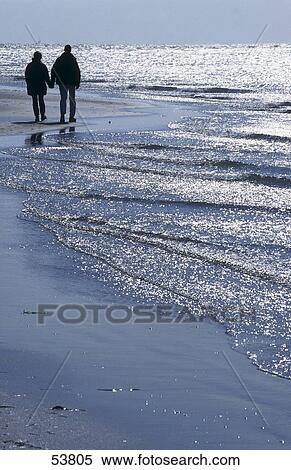 Stock Photography - Silhouette of couple on beach, Adria, Italy . Fotosearch