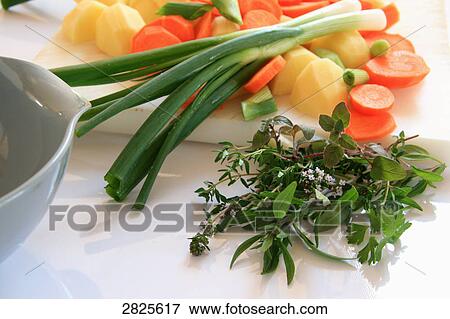 Slices of carrot with potato and spring onion on cutting board View Large Photo Image Stock Photo - Slices of carrot with potato and spring onion on cutting board . Fotosearch