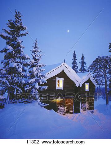 Snow covered wooden house in field  View Large Photo Image Stock Image - Snow covered wooden house in field . Fotosearch