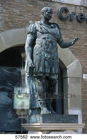 Stock Image - Statue of Gaius Julius Caesar on pedestal, Piazza Tre Martiri, Rimini, Emilia Romagna, Italy . Fotosearch